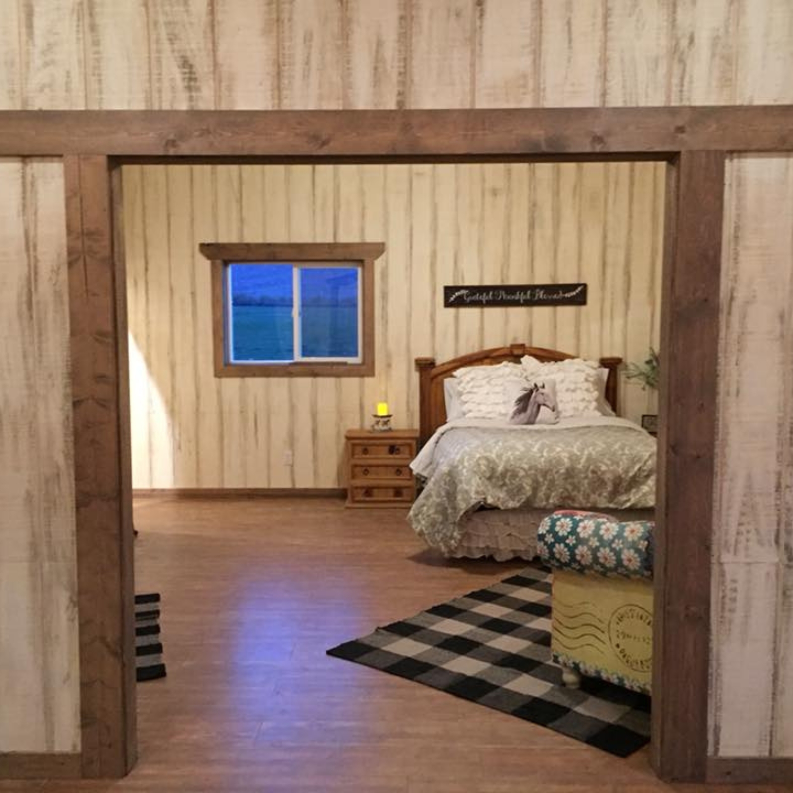 rustic guest cabin with open concept showing bedroom with couch
